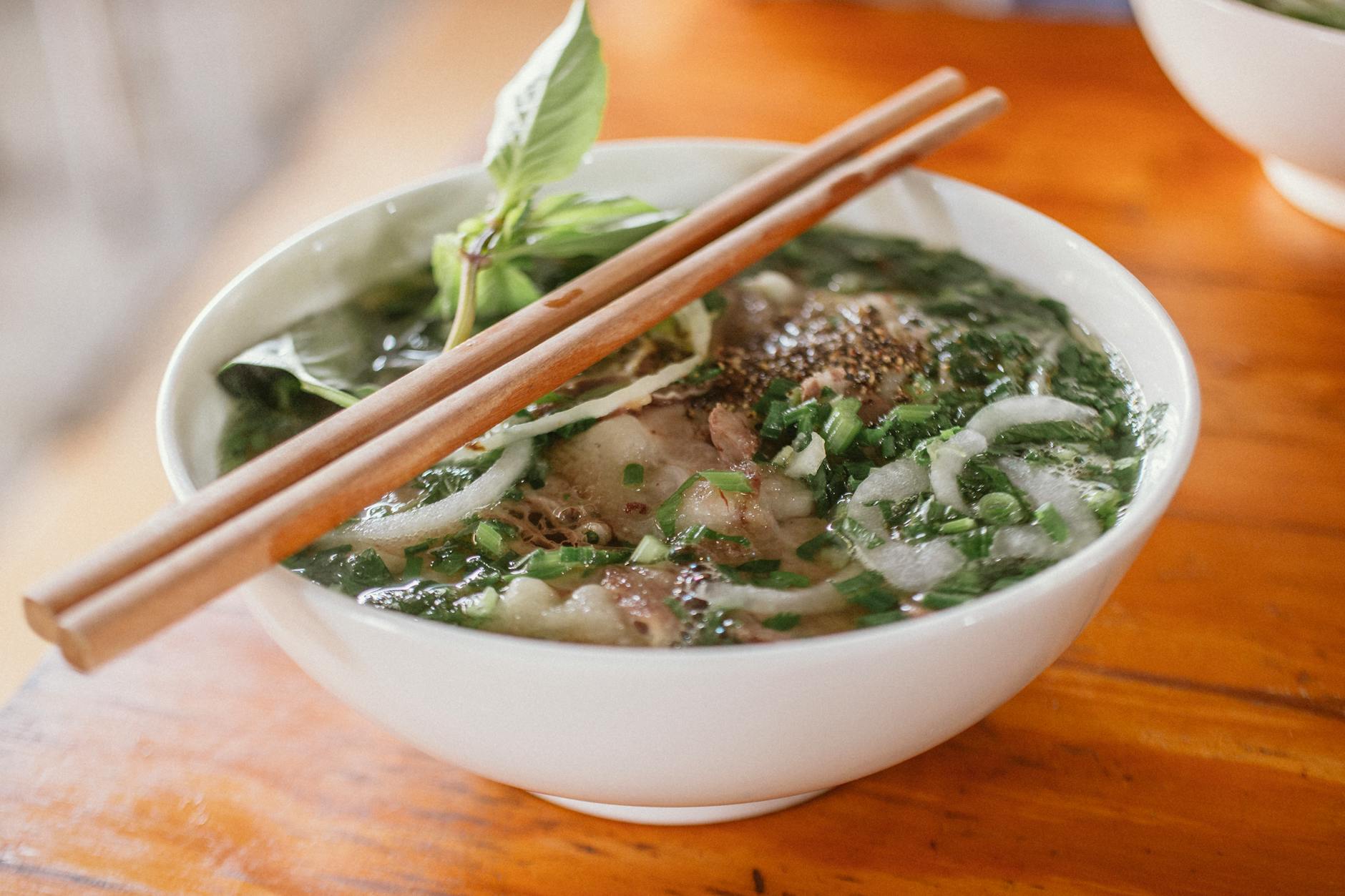 pho soup noodles in white ceramic bowl