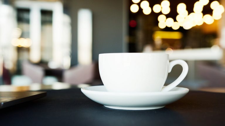 white ceramic cup and saucer on table