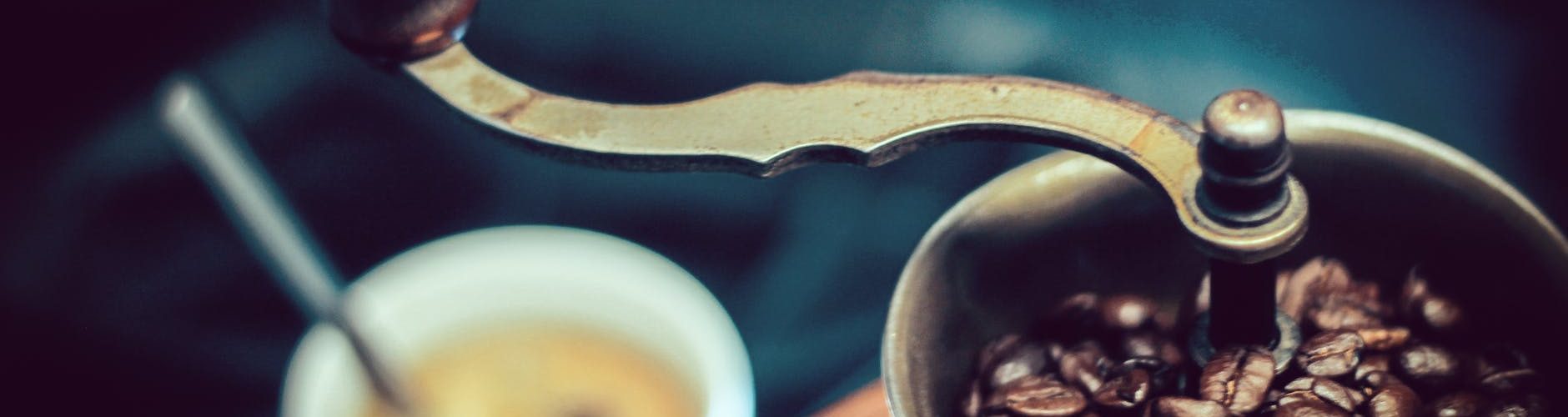 selective focus photography of vintage brown and gray coffee grinder