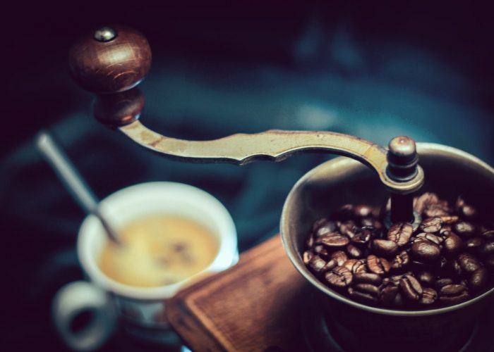 selective focus photography of vintage brown and gray coffee grinder