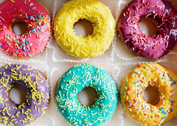 pink doughnut on white textile