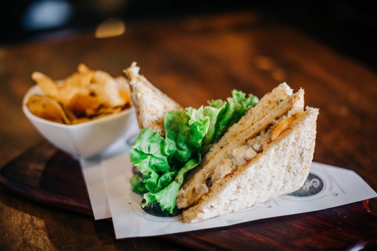 bread with green vegetable on white paper
