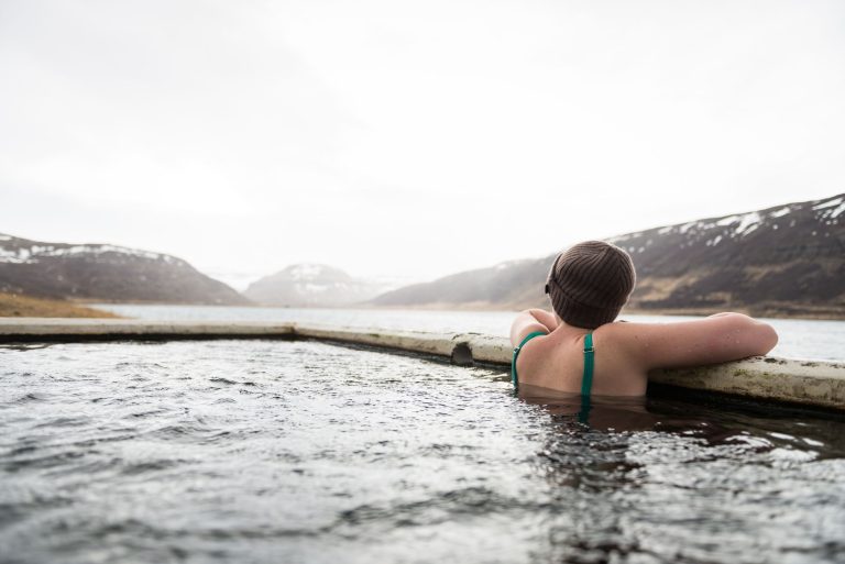 a person wearing knit cap soaking in a pool
