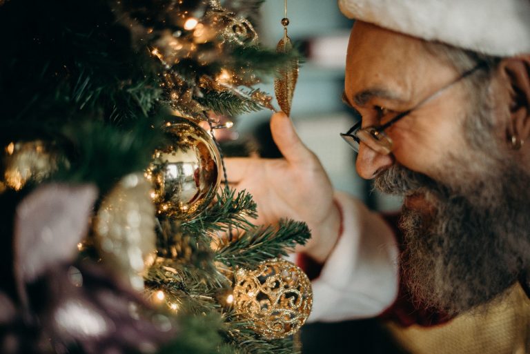 man looking at gold bauble