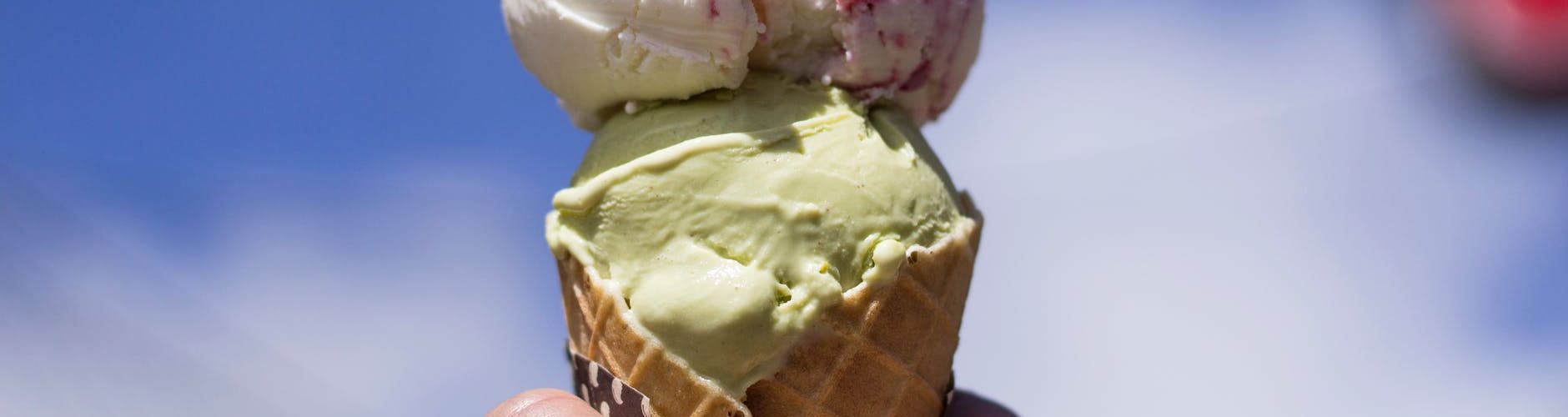 person holding ice cream with cone