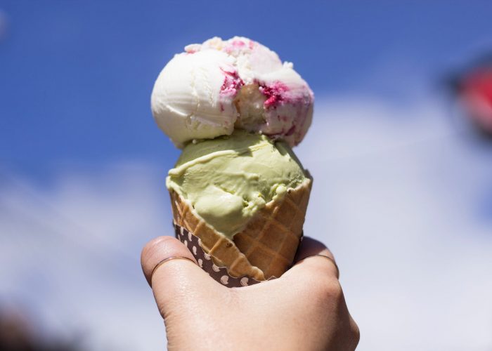 person holding ice cream with cone