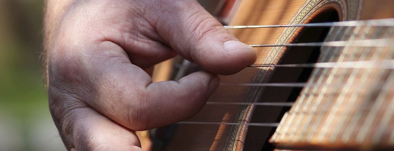 Musician playing guitar, music background