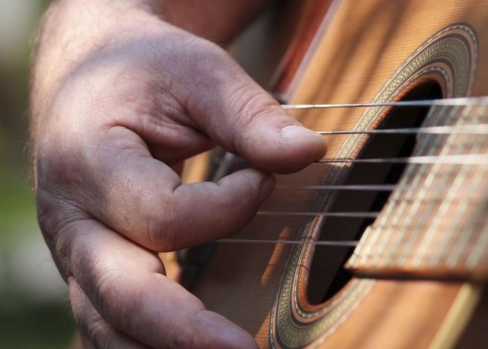 Musician playing guitar, music background