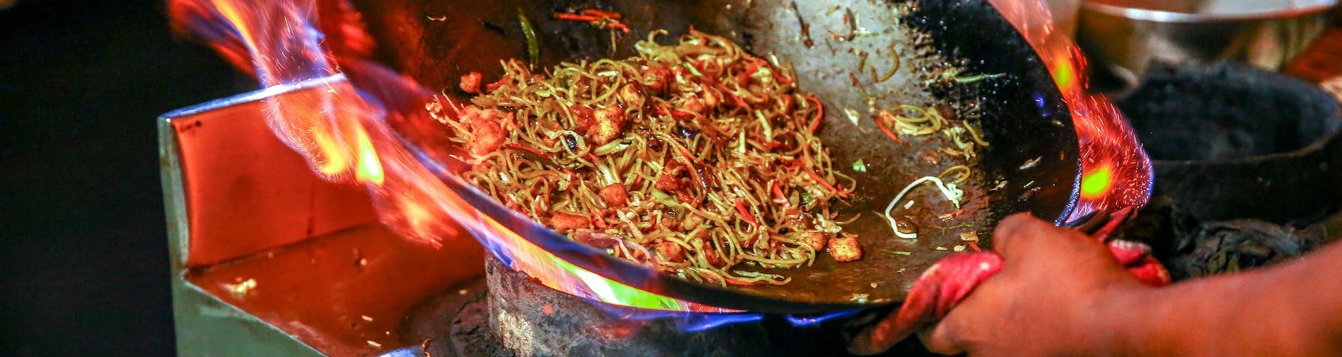 person cooking noodles