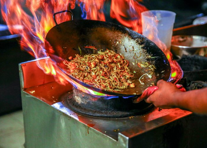 person cooking noodles