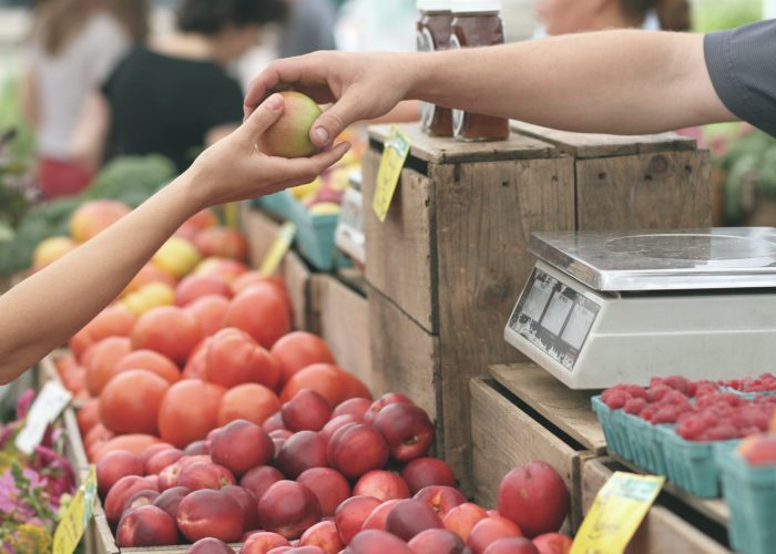 person giving fruit to another