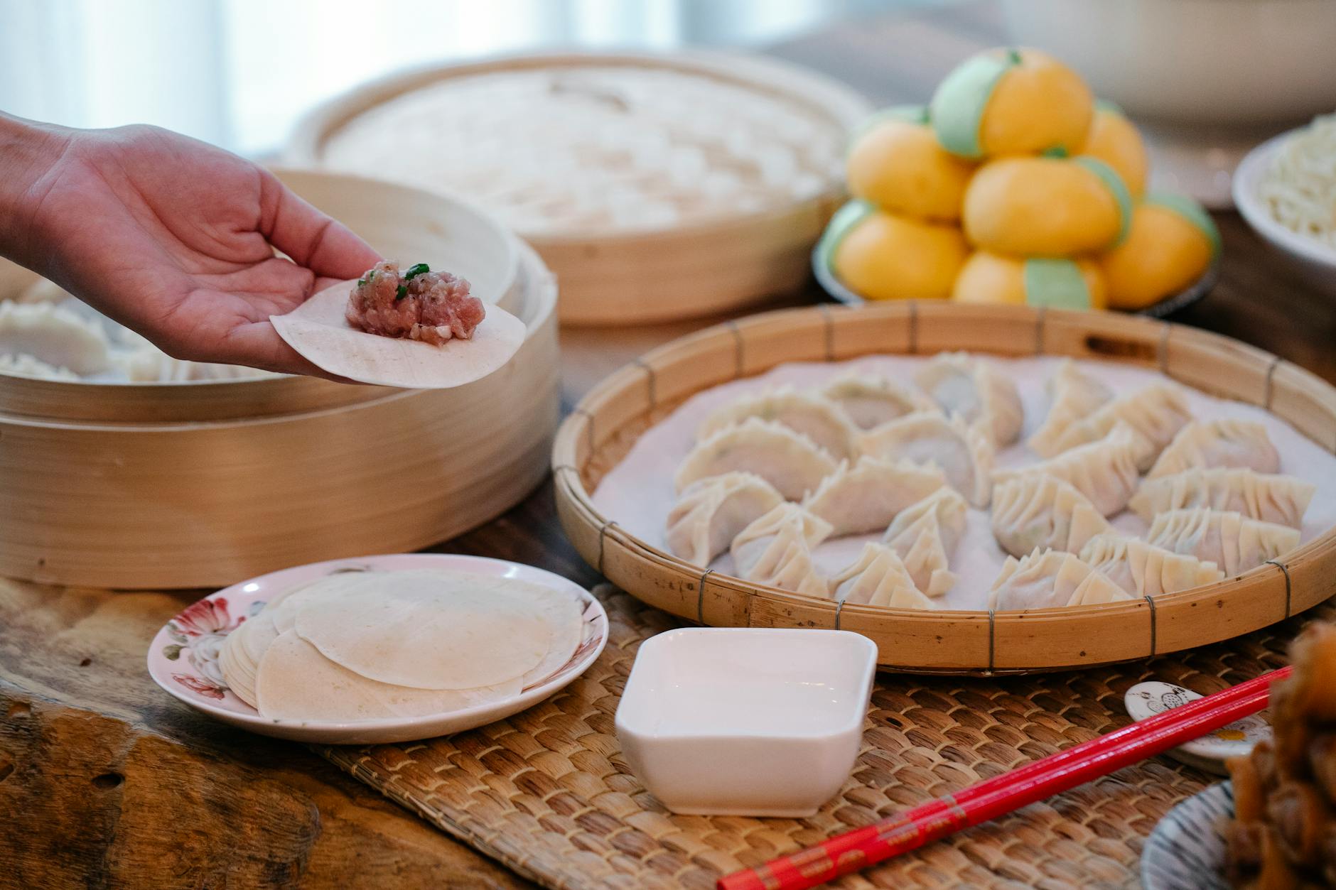 anonymous cook filling dumpling with meat