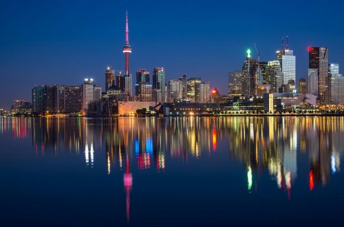 buildings near body of water at night