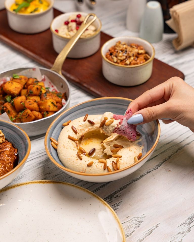 woman hand over bowl and tray with food
